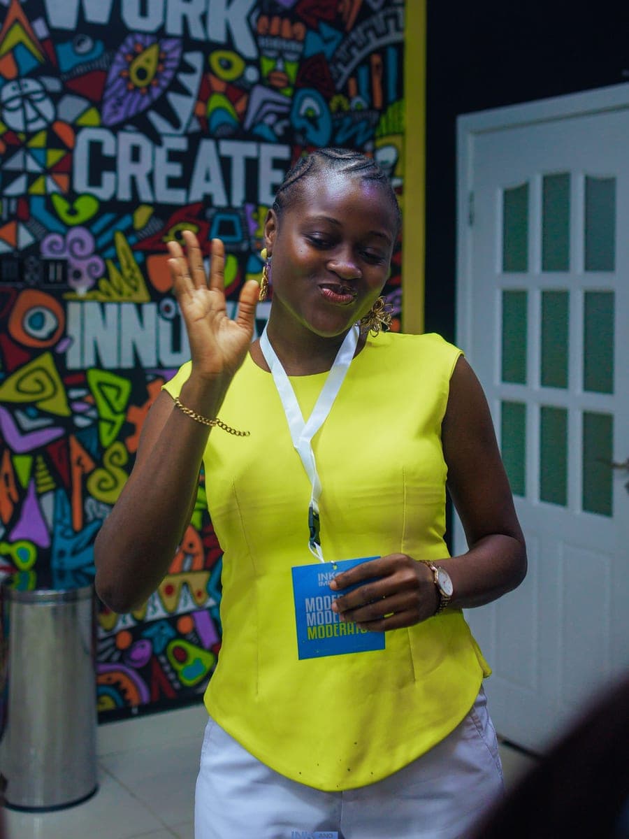 A member in front of the Create / Innovate mural