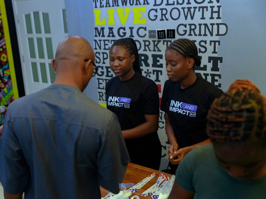 A member standing to speak at Ink & Impact 2.0