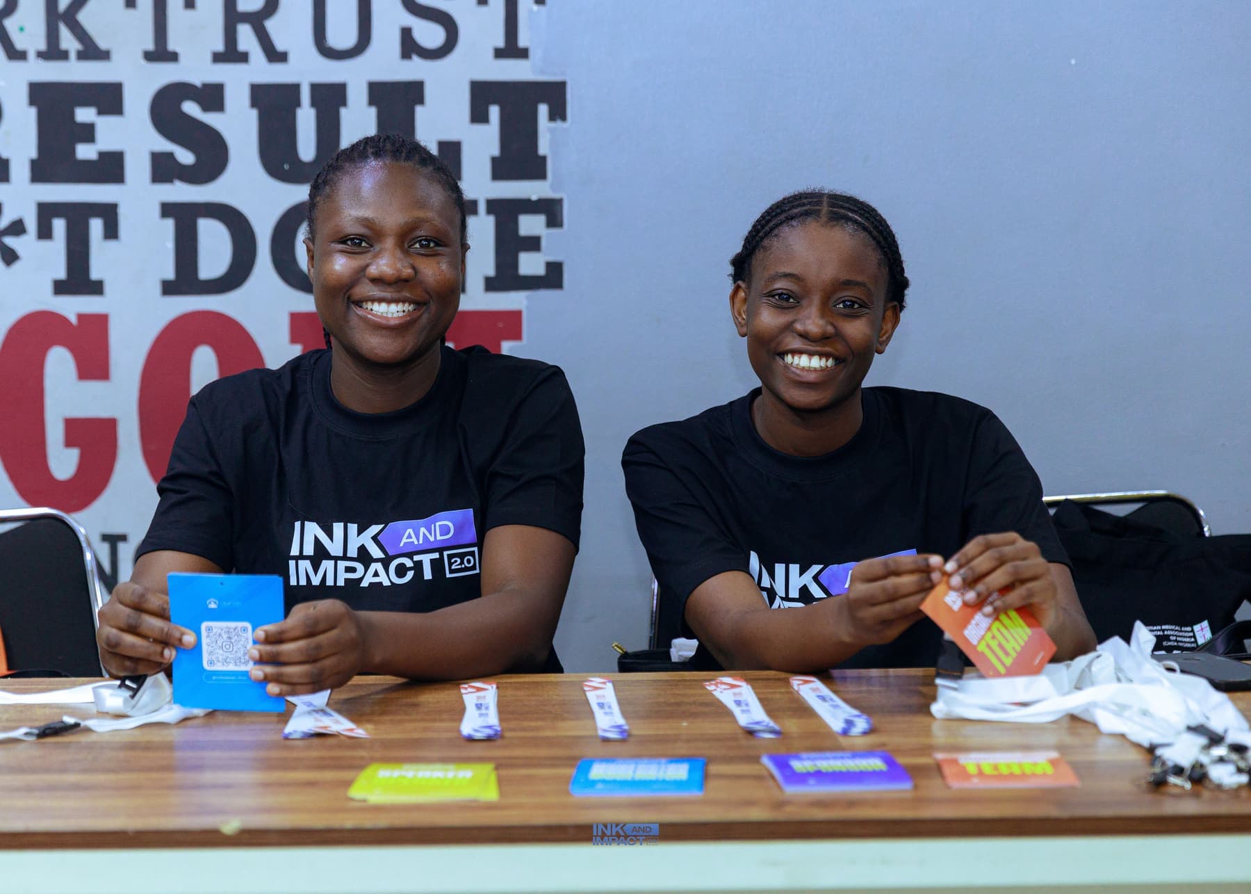 Two members at the Ink & Impact 2.0 welcome desk