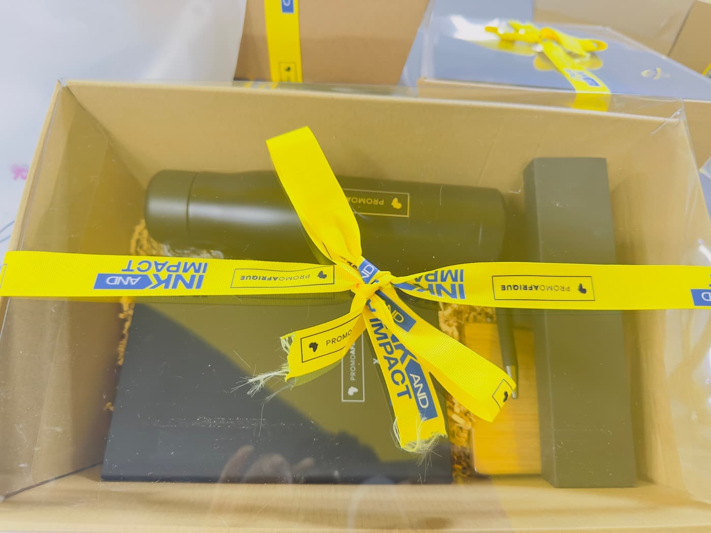 An Ink & Impact 2.0 gift box tied with branded ribbon