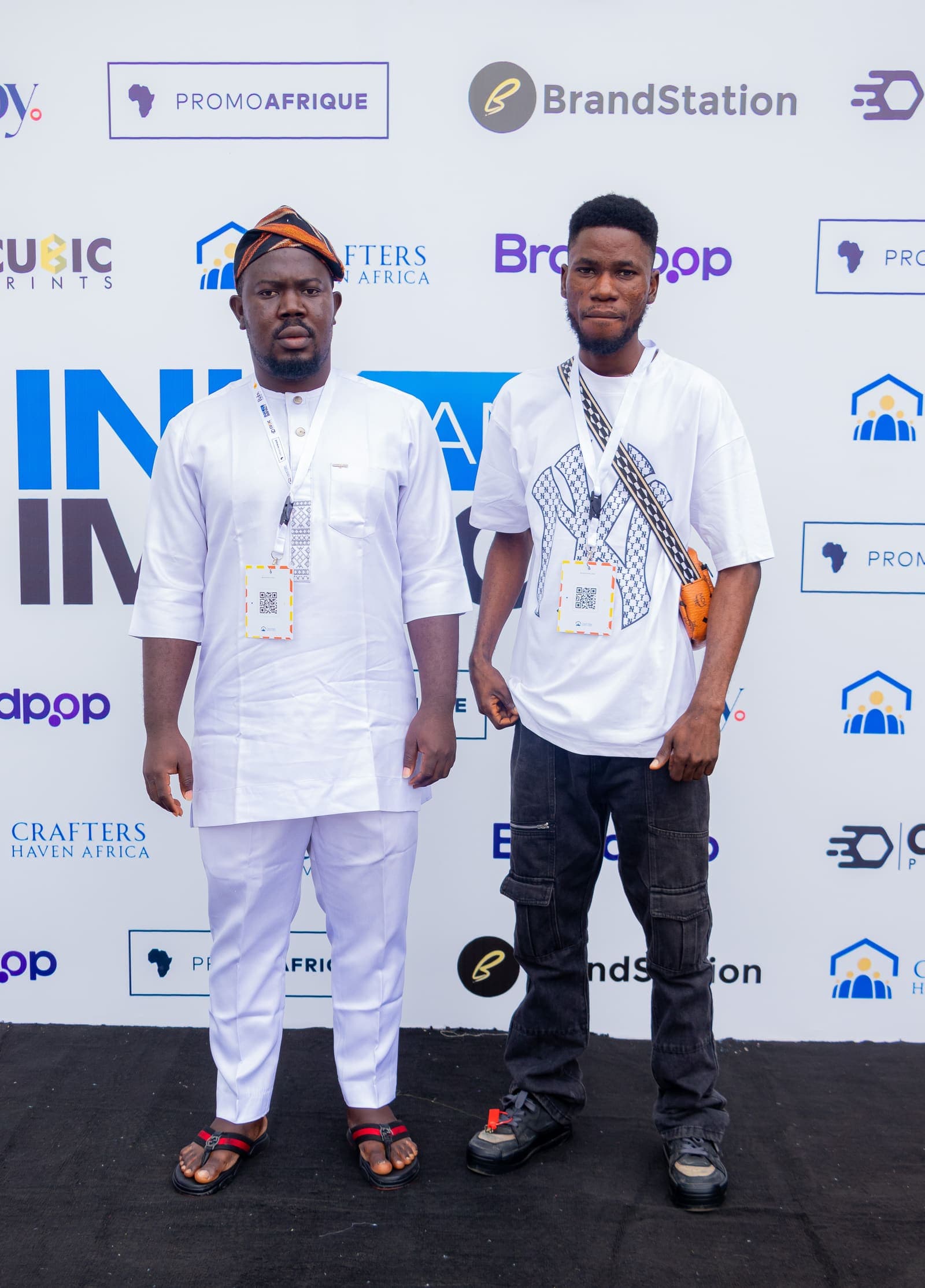 Two members at the Ink & Impact 1.0 backdrop