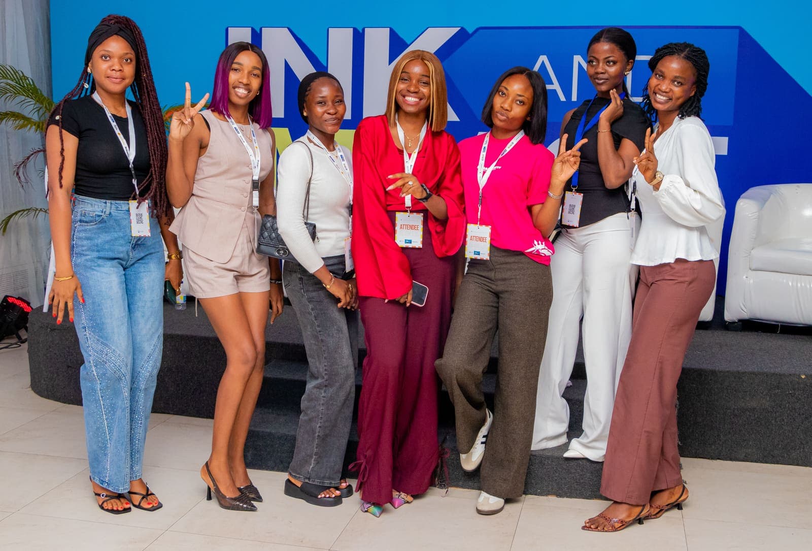 Members together at the Ink & Impact 1.0 backdrop