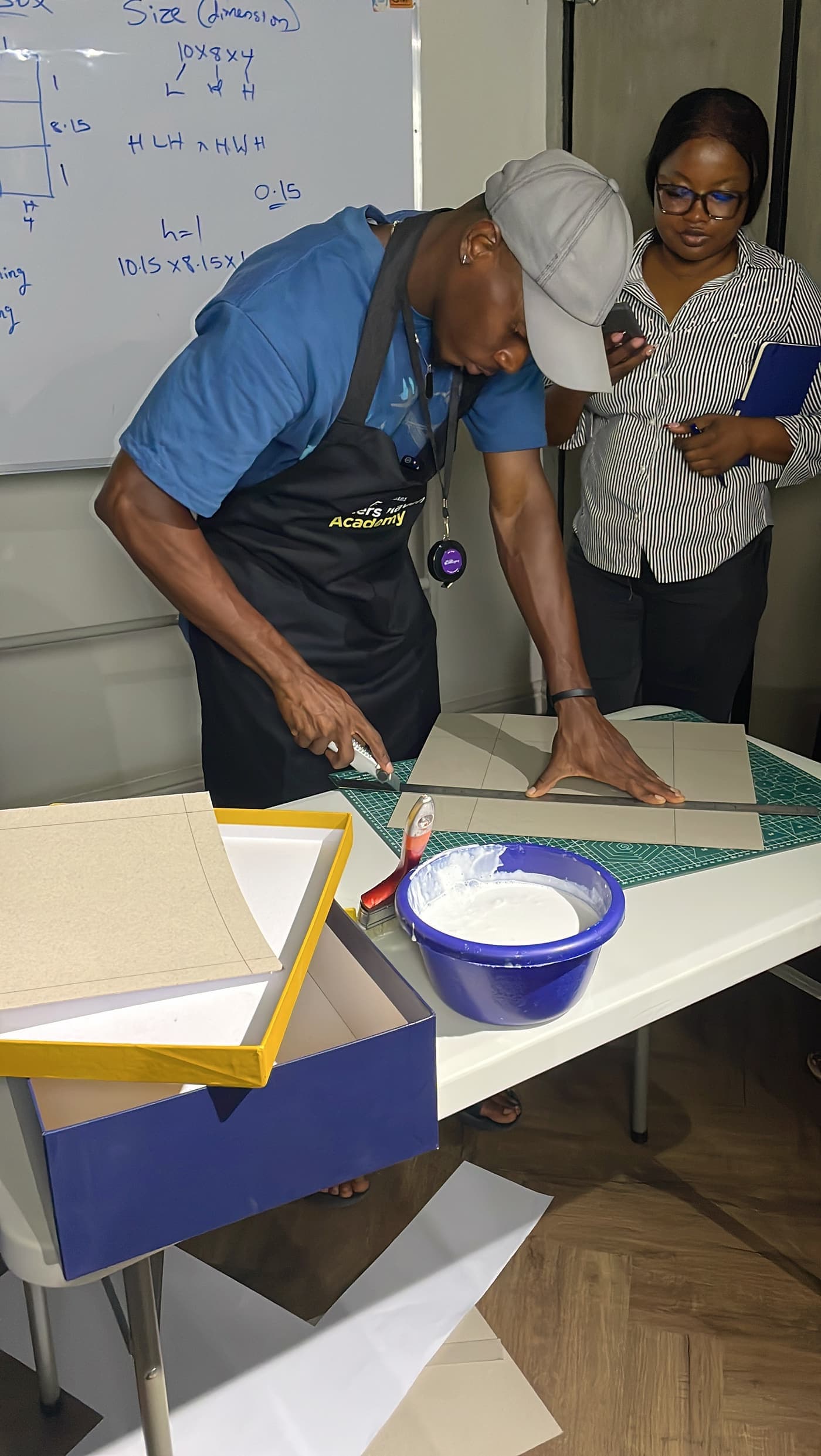 A trainer scoring board on a cutting mat during a Crafters Haven Academy session