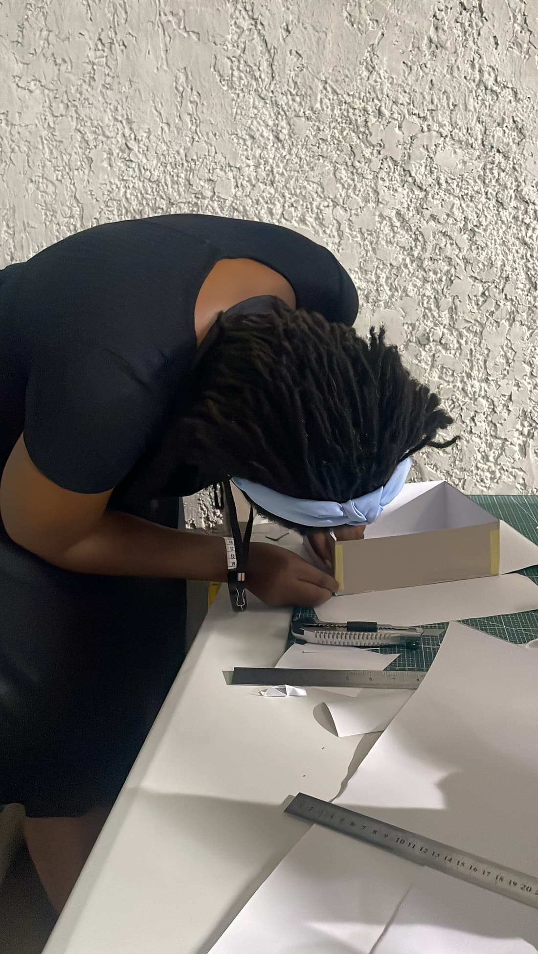 A cohort member assembling a rigid box by hand