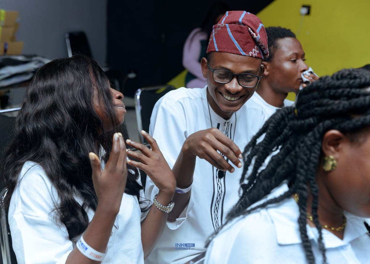 Members talking and laughing between sessions at Ink & Impact 2.0
