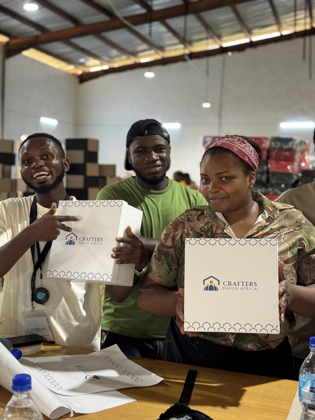 Cohort members with the branded boxes they produced