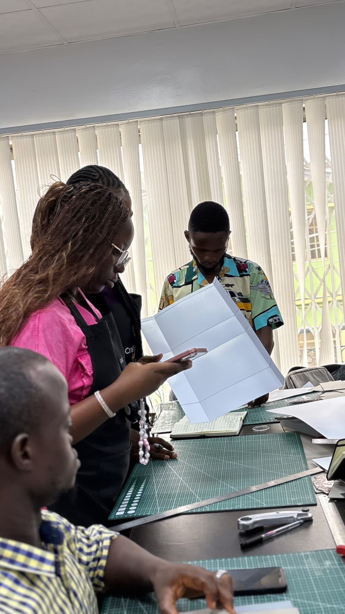 Members reviewing printed work together