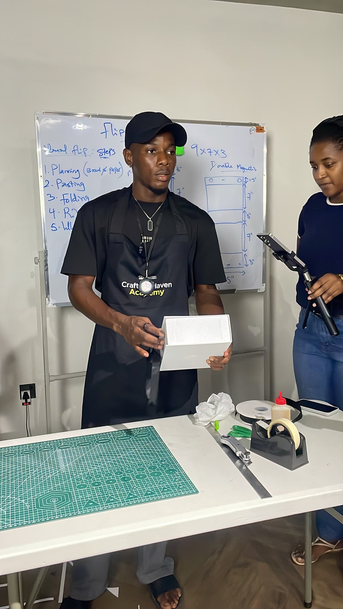 A trainer holding up a finished box shell