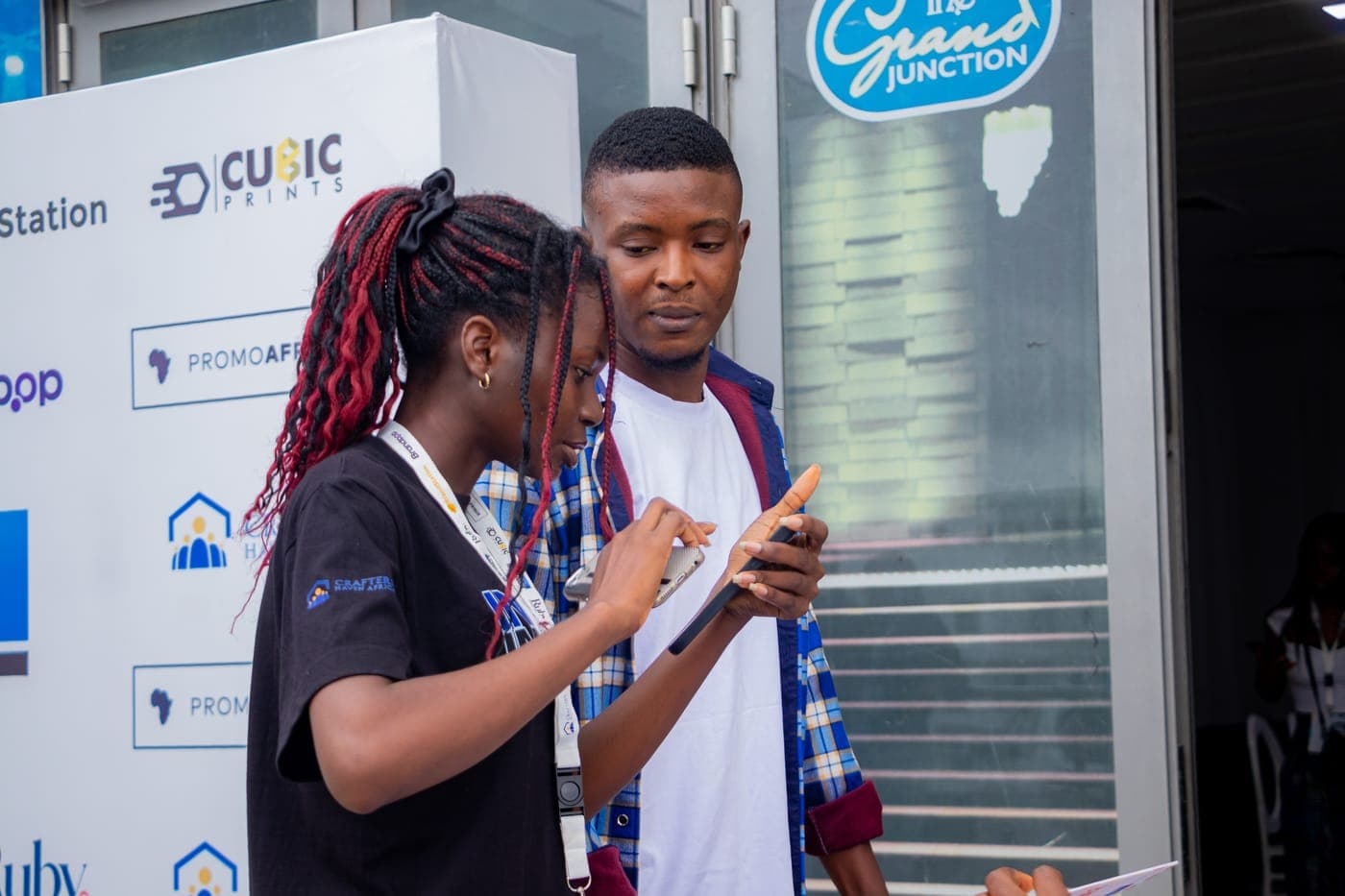 Two members swapping contacts outside the hall